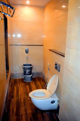 Modern private bathroom with wooden flooring at Hotel Delhi Empire DX, Paharganj