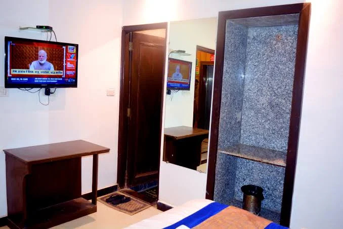 Delhi Empire DX Room — deluxe room with blue accent linens and king-size bed