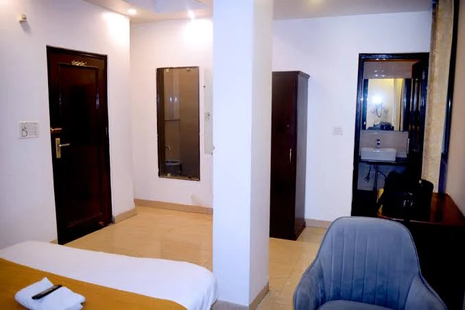 Family suite interior at Delhi Empire DX with seating area and adjoining bathroom